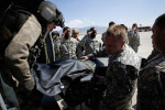 The body of Captain Petre Tiberius is unloaded from a helicopter by fellow Romanian soldiers and American medical personnel at Bagram Air Field in Afghanistan on April 3, 2009. The defense ministry in Bucharest, Romania announced Captain Petre Tiberius was killed in crossfire while leading a mission on Friday to support ISAF forces who had come under attack. Tiberius was transported by helicopter to a forward surgical hospital but died in transit. Romania has lost 10 soldiers in Afghanistan. 