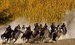 Riders chase down the man with the calf as they try to prevent him from dropping it in the circle during a game of Buzkashi in Khenj, Afghanistan on Friday, October 26, 2007. Each time a rider successfully completes the task he is cheered by the village and wins money.