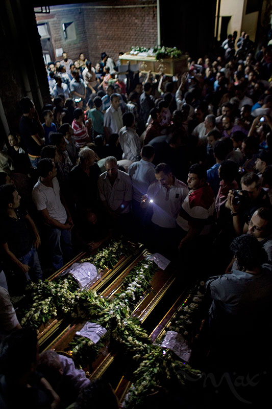 CAIRO, EGYPT. Coptic Christian Egyptians mourn more than a dozen killed during clashes with the Egyptian army late Sunday as the bodies are collected in coffins at the Coptic Hospital in Cairo, Egypt. The victims were killed during clashes at a protest by Coptic Christians demanding better protection and accountability for several church burnings this year.