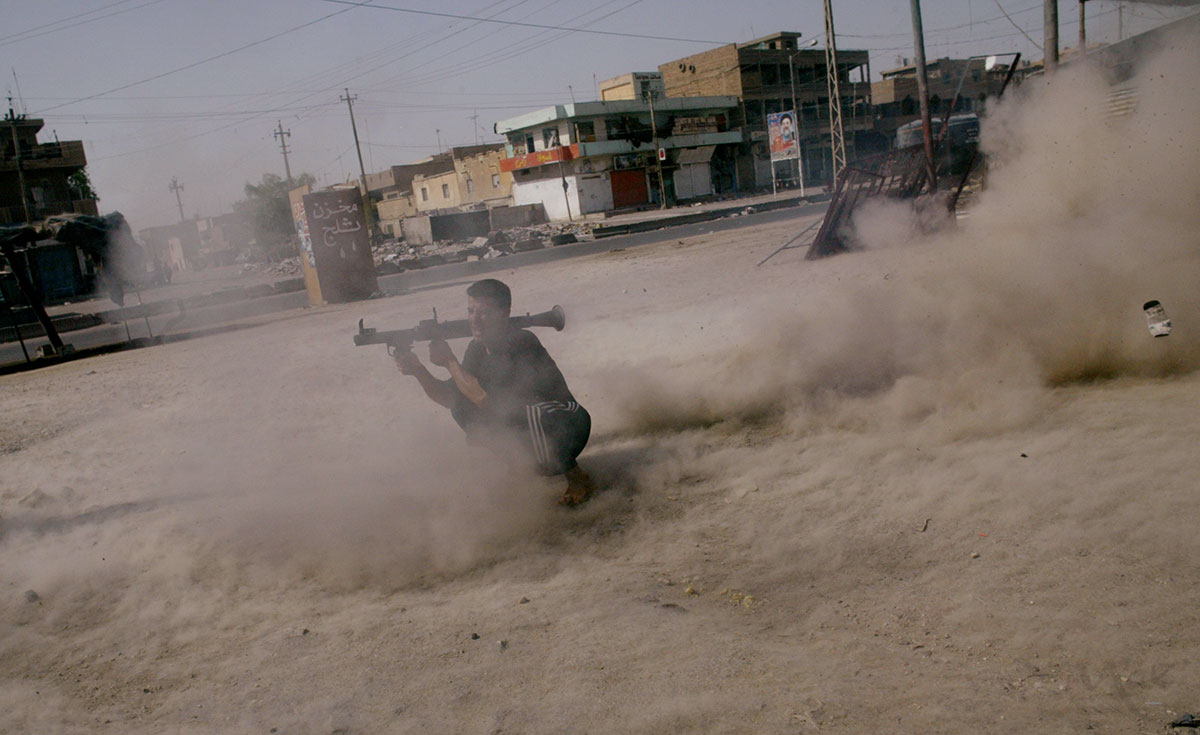 A member of cleric Muqtada al-Sadr’s Mehdi Army fires a rocket propelled grenade at a U.S. Army tank, which has taken up position on the south side of Sadr City. Clashes between the Mehdi Army and the U.S. military continued today in Sadr City as maneuvers were being made to end the standoff in Najaf between al-Sadr and the new Iraqi government. 