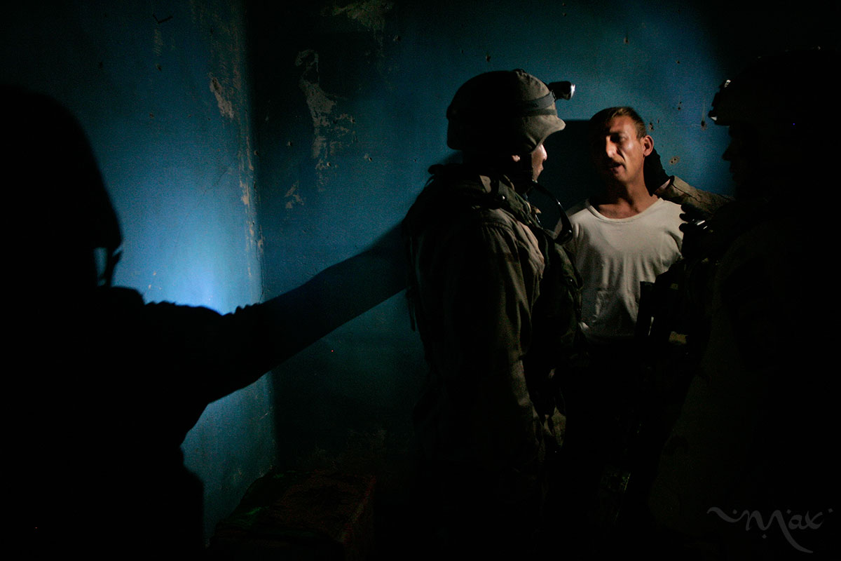 U.S. soldiers, with the 1st Battalion, 24th Infantry Regiment, Bravo Company, question a man charged with being part of a mortar and improvised explosive device team in the Islah Zeral neighborhood of Mosul. U.S. and Iraqi Army forces raided his home and detained four other men after receiving a tip from Iraqi Army intelligence that the men in the home were part of a skilled mortar and IED making team. The soldiers hoped that the detained men would lead them to their mortars, but they did not. The men were taken into Iraqi Army custody and then later released to U.S. custody. One of the men detained was a master sergeant in Saddam Hussein’s Republican Guard, trained as a mortar man. A Mosul police station, called Four West, had received forty to fifty well-targeted rounds in the last few months by this team of men.