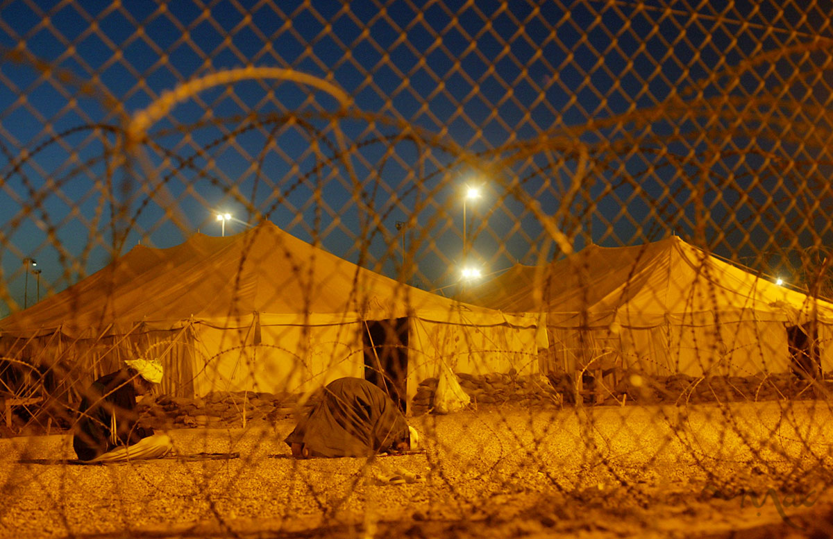  Detainees pray, as dawn breaks over the level-one detention area of Camp Redemption at the Abu Ghraib prison complex. The camp has level one to four detention levels with the level-one camp housing the best-behaved prisoners. This camp was built after the prisoner abuse scandal made the prison infamous. The U.S. released the buildings where the abuse took place to the control of the Iraqis and now runs its operations in this new camp.  