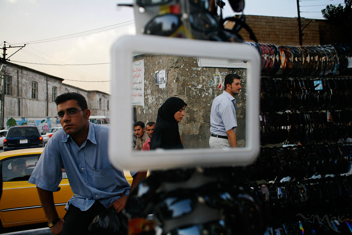 People are reflected in a mirror of a roadside sunglasses vendor at Sulaymaniyah’s main market in Iraq’s northern Kurdish region. More merchandise is available for sale in Iraq’s Kurdish region since its border with Turkey provides a safe entry to the area. As the rest of Iraq struggles with sectarian killings and an insurgency, the mostly homogenous Kurdish north prospers and benefits from reconstruction projects. Since the partitioning of the Ottoman Empire, the Kurds have sought to have an autonomous country, and still today many Kurds express their desire to make themselves independent from the troubles of greater Iraq. 