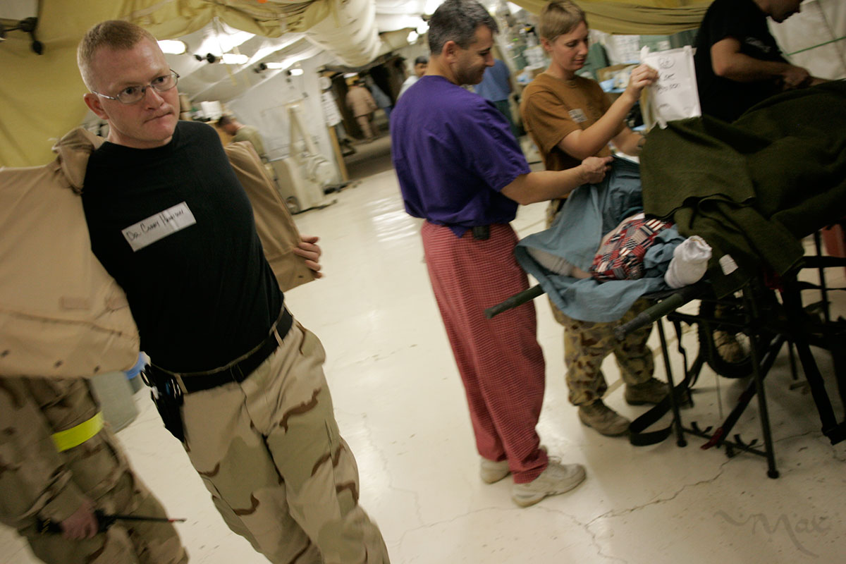 Emergency room doctor, Major Corey Harrison at the Theater Medical Hospital, run by the 332nd Expeditionary Medical Group, takes his flak vest off as he rushes to treat wounded American soldiers in Balad, Iraq on October 30, 2005. 