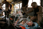 Tech Sergeant Darrell Waite, right, with the Critical Care Aeromedical Team (CCAT) transport a critically wounded Marine from the Balad Theater Medical Hospital in Balad, Iraq to a waiting aircraft ready to fly to Landstuhl, Germany. 