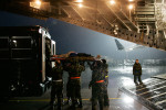 A wounded soldier is carried off of a C-17 aircraft to a rainy flight line at Ramstein Air Base after taking a five-hour flight from Iraq. Soldiers are transported on a C-17 plane from Iraq to Ramstein Air Force Base in Germany. The wounded are then transported to buses and driven to the Landstuhl Regional Medical Center where their wounds will be further repaired, cleaned and treated. By the time the wounded reach Germany they face mainly operations of recovery as opposed to life saving operations.