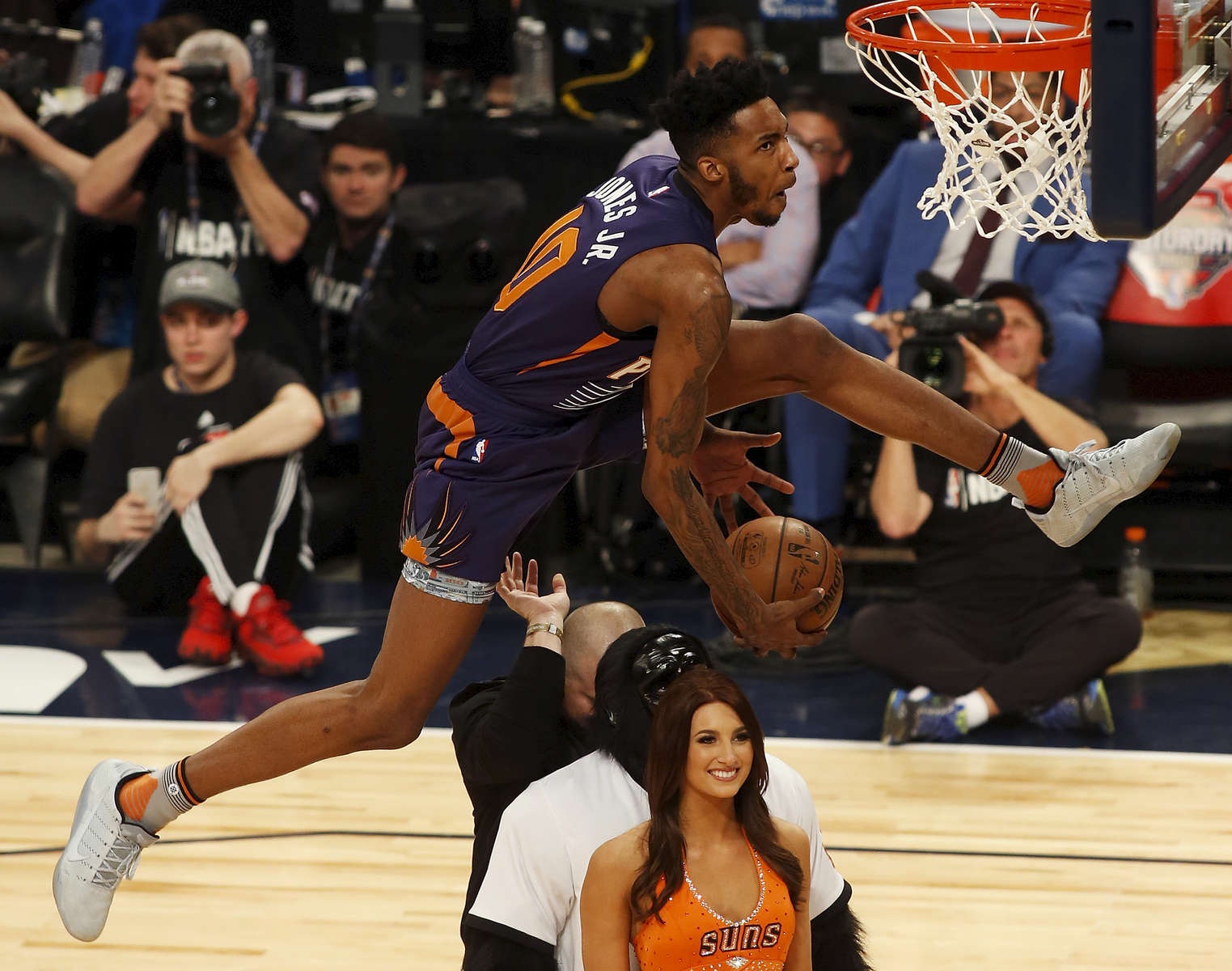 Phoenix Suns forward Derrick Jones Jr. (10) leaps over three people during the slam-dunk contest as part of the NBA All-Star Saturday Night events in New Orleans, Saturday, Feb. 18, 2017. (AP Photo/Max Becherer)
