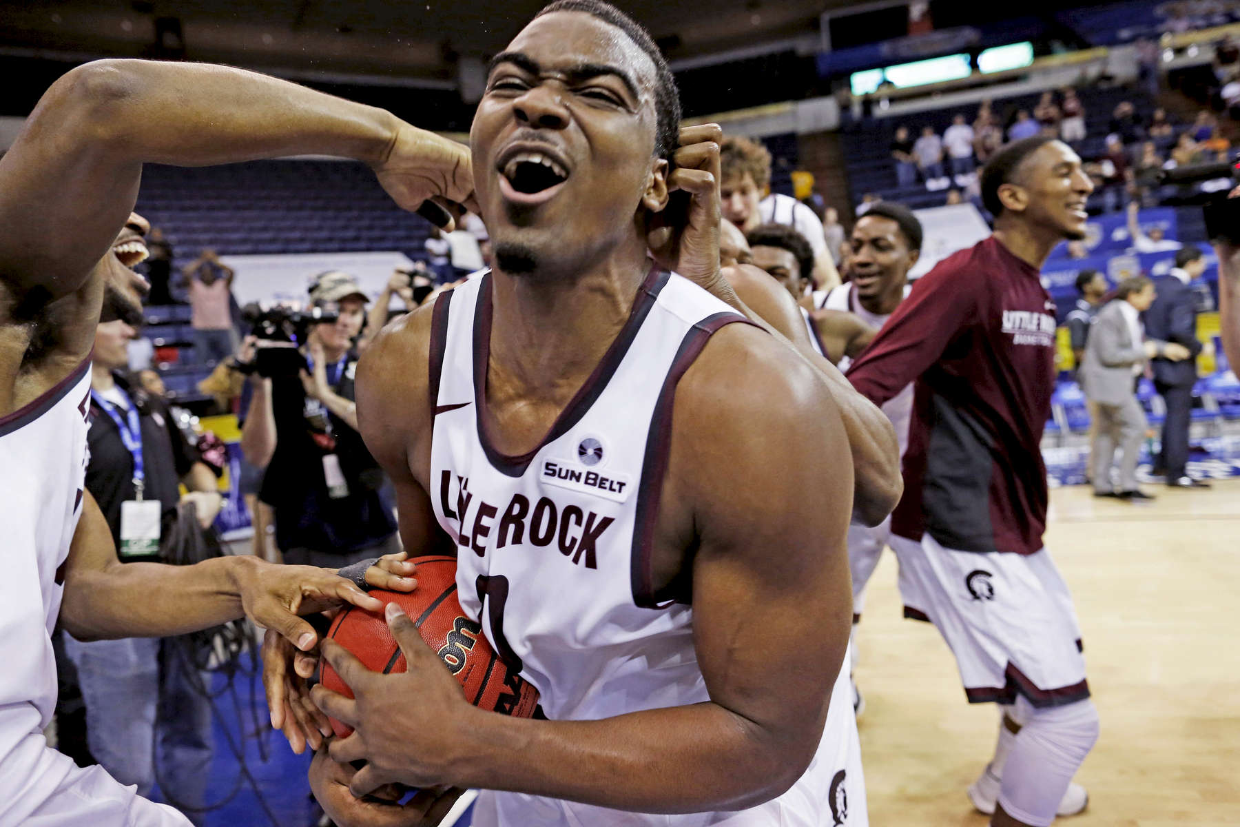 Arkansas Little Rock forward Roger Woods (0) celebrates the win over Louisiana Monroe with his teammates at the conclusion of an NCAA college basketball game in the championship of the Sun Belt Conference men's tournament in New Orleans, Sunday, March 13, 2016. Arkansas Little Rock beat Louisiana Monroe 70-50. (AP Photo/Max Becherer)