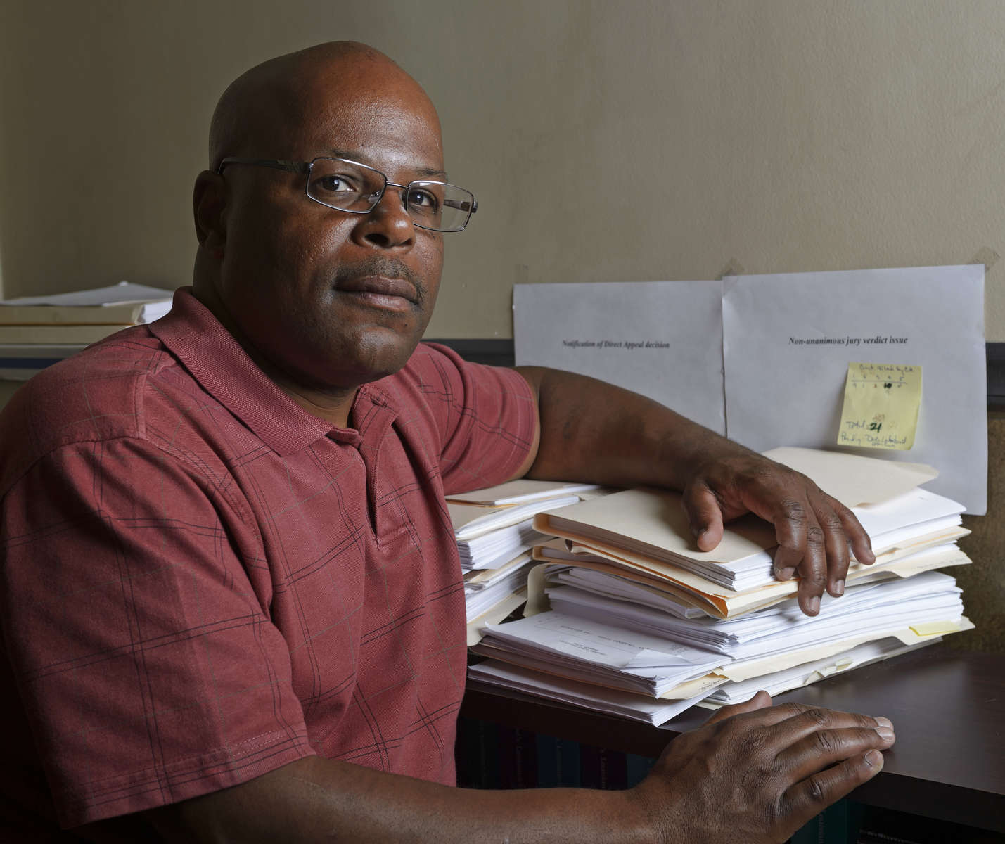 Portraits included in non-unanimous jury project that was awarded the 2019 Pulitzer Prize for Local Reporting. Calvin Duncan poses for a photo with two stacks of legal paperwork filed under {quote}Notification of Direct Appeal Decision{quote} and Non-unanimous Jury Verdict issues{quote} in his Central Business District office in New Orleans, La., Friday, Feb. 23, 2018. Duncan is a former Angola inmate who is pushing the United States Supreme Court, through repeated petitions on behalf of inmates convicted on non-unanimous jury counts, to overturn the state's unusual law allowing murder convictions of a 10 to 2 jury serious felony cases.