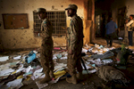 PESHAWAR, PAKISTAN. Pakistan Army soldiers inspect the damage done to the Army Public School and Degree College in Peshawar, Pakistan on Wednesday, December 17, 2014 where Taliban gunmen killed 150 people, many of them children, the day before. Empty bullet casings, pools of blood and personal belongings littered the floors.