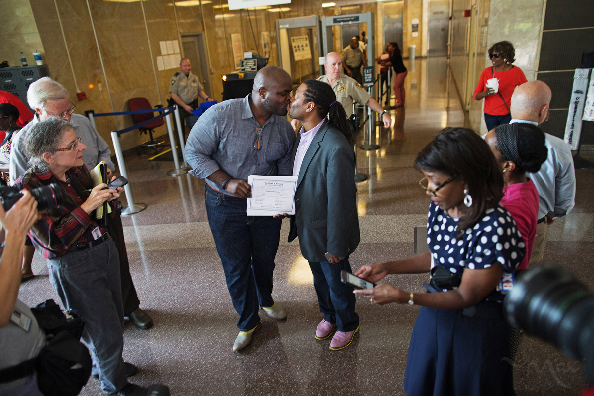 NEW ORLEANS, LOUISIANA. Earl Benjamin, left, and Michael Robinson, show their marriage certificate and kiss in the New Orleans Parish Civil District Court building after becoming the first legally gay couple to wed in New Orleans, Louisiana. Robinson and Benjamin had been together for almost 14 years before exchanging vows in the civil ceremony. (Max Becherer/Polaris)