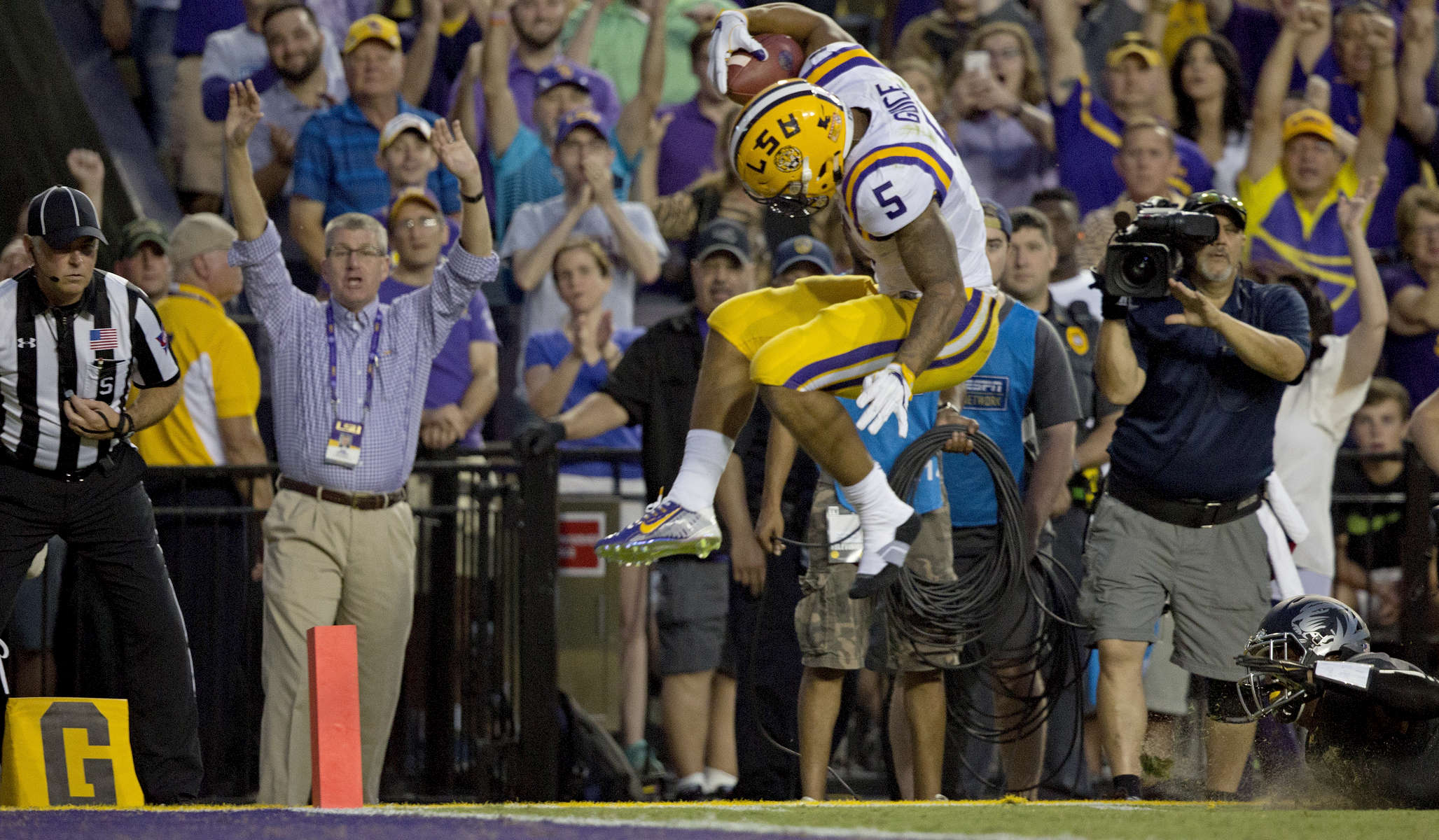 LSU running back Derrius Guice (5) leaps into the end zone in front of Missouri safety Thomas Wilson (8) during the first half of an NCAA college football game in Baton Rouge, La., Saturday, Oct. 1, 2016. (AP Photo/Max Becherer)