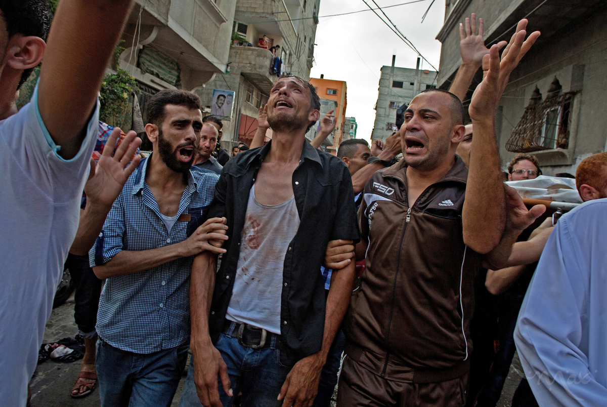 Families mourn as they walk in a procession to the graveyard to bury a dead child after a rocket attack killed at least 10 people and wounded 46 on July 28, 2014. The rockets landed on a park in Gaza City in the Gaza Strip where children were playing in celebration of Eid al-Fitr, the holiday marking the end of the Muslim holy month of Ramadan.