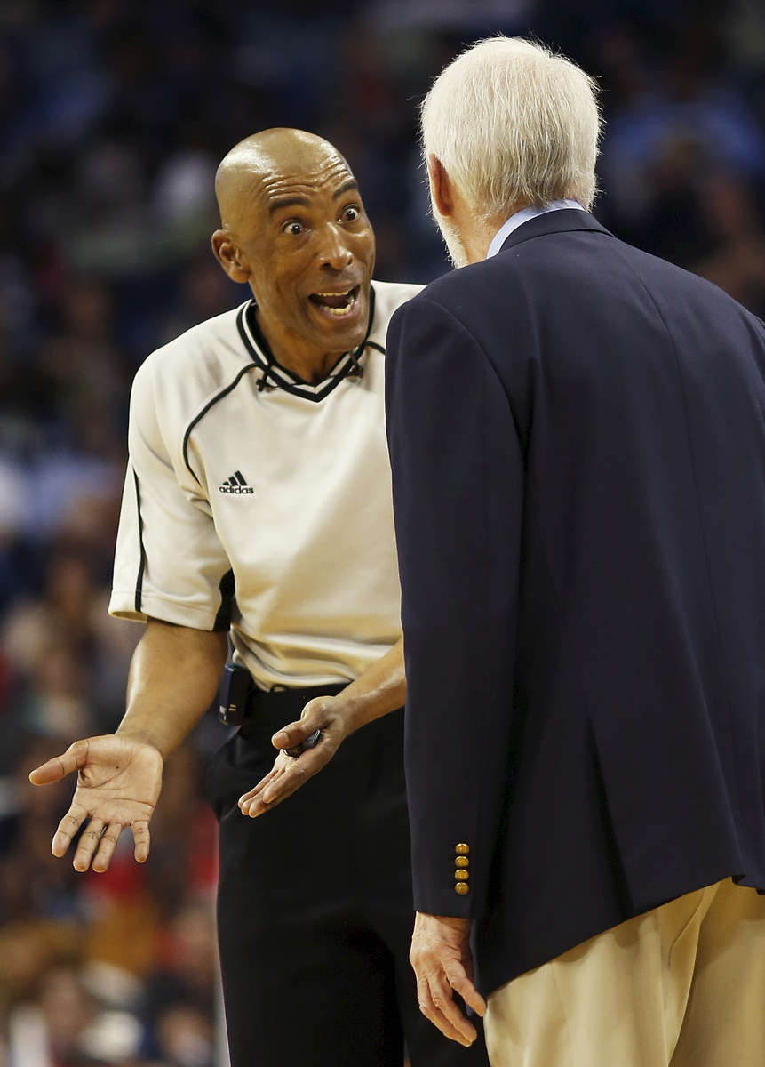 Referee Leon Wood talks to San Antonio Spurs head coach Gregg Popovich in the first half of an NBA basketball game in New Orleans, Thursday, March 3, 2016. The Spurs beat the Pelicans 94-86. (AP Photo/Max Becherer)