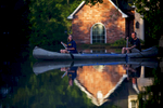 PRAIRIEVILLE, LOUISIANA. Danny and Alys Messenger canoe away from their flooded home after reviewing the damage in Prairieville, La., Tuesday, Aug. 16, 2016. Historic August flooding in southern Louisiana killed 13 people, forced tens of thousands of people to flee and damaged as many as 112,000 homes. (AP Photo/Max Becherer)