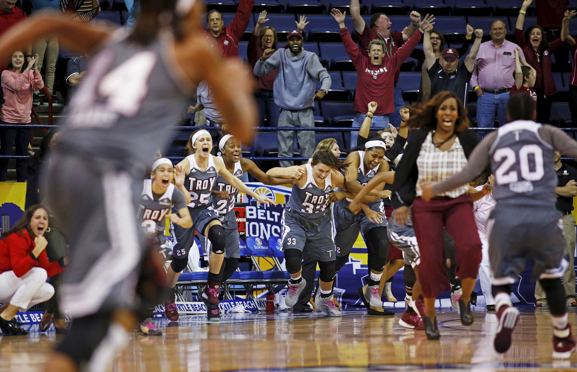 The Troy bench explodes in celebration after beating Arkansas Little Rock during an NCAA college basketball game in the championship of the Sun Belt Conference women's tournament in New Orleans, Saturday, March 12, 2016. Troy won 61-60 after guard Ashley Beverly Kelley scored with 20.2 seconds on the clock. (AP Photo/Max Becherer)