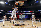 Eastern Conference small forward Giannis Antetokounmpo of the Milwaukee Bucks (34) slam dunks as Western Conference guard Stephen Curry of the Golden State Warriors (30) lies on the court during the first half of the NBA All-Star basketball game in New Orleans, Sunday, Feb. 19, 2017. (AP Photo/Max Becherer)