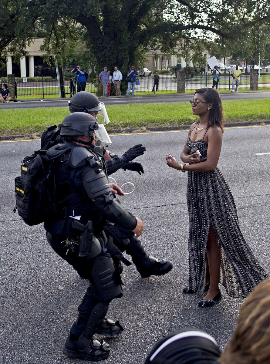 Ieshia Evans, 35, is grabbed by police officers in riot gear after she refused to leave the motor way in front of the the Baton Rouge Police Department headquarters in Baton Rouge, La. USA, Saturday, July 09, 2016. Spokeswoman Casey Rayborn Hicks of the East Baton Rouge Sheriff's Office said 101 people were taken to the parish jail in connection with the protests Saturday. (AP Photo/Max Becherer)