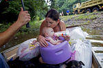 Danielle Blount kisses her 3-month-old baby Ember and feeds her while they wait to be evacuated by members of the Louisiana Army National Guard near Walker, La. USA, after heavy rains inundated the region, Sunday, Aug. 14, 2016. Downpours in some areas of southern Louisiana came close to 2 feet over a 48-hour period according to the National Weather Service. (AP Photo/Max Becherer)