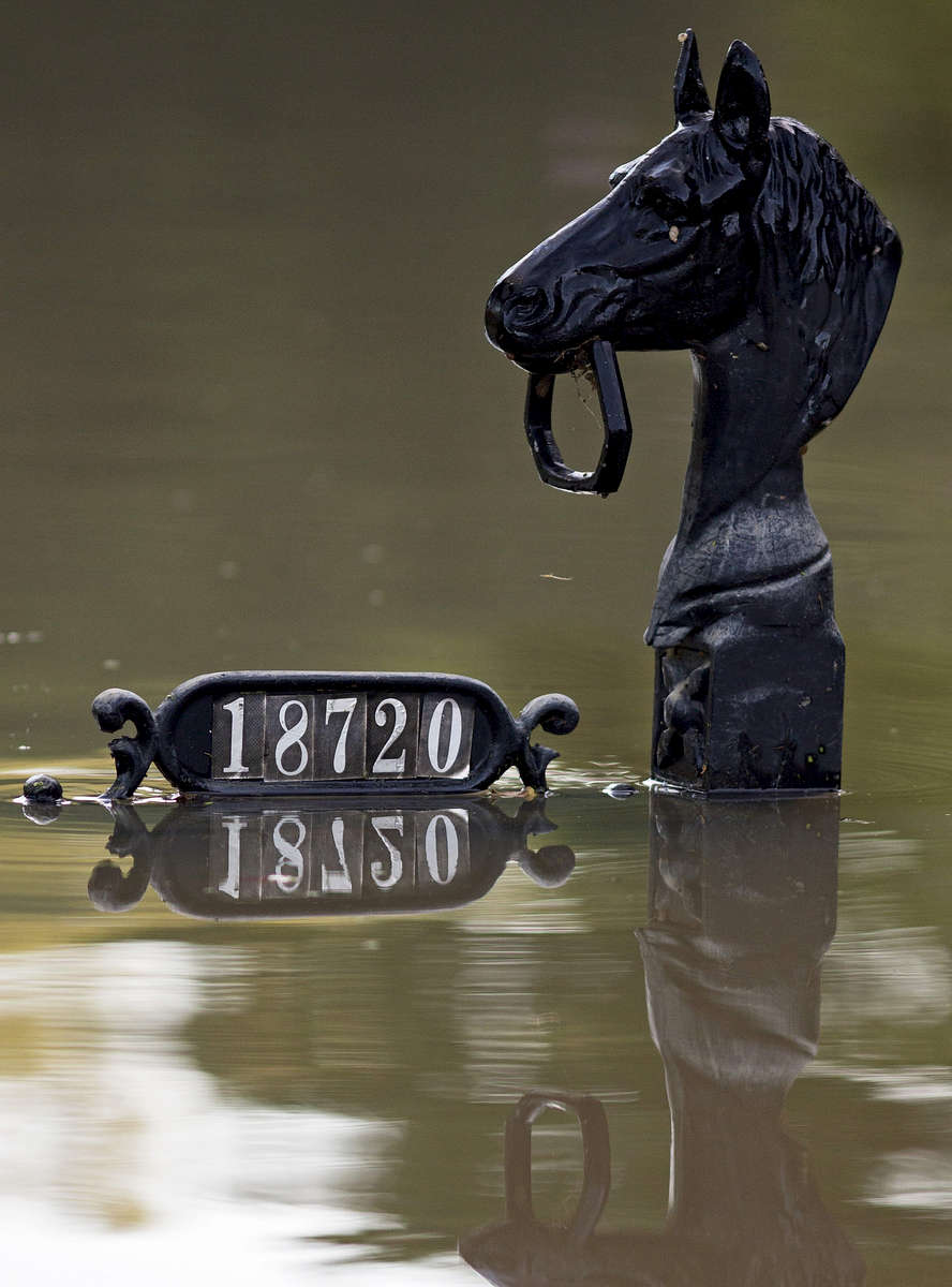 Mailbox posts are seen just above flood water in Prairieville, La. USA, Tuesday, Aug. 16, 2016. At least 40,000 homes were damaged in the historic Louisiana floods, according to Louisiana Gov. John Bel Edwards. (AP Photo/Max Becherer)