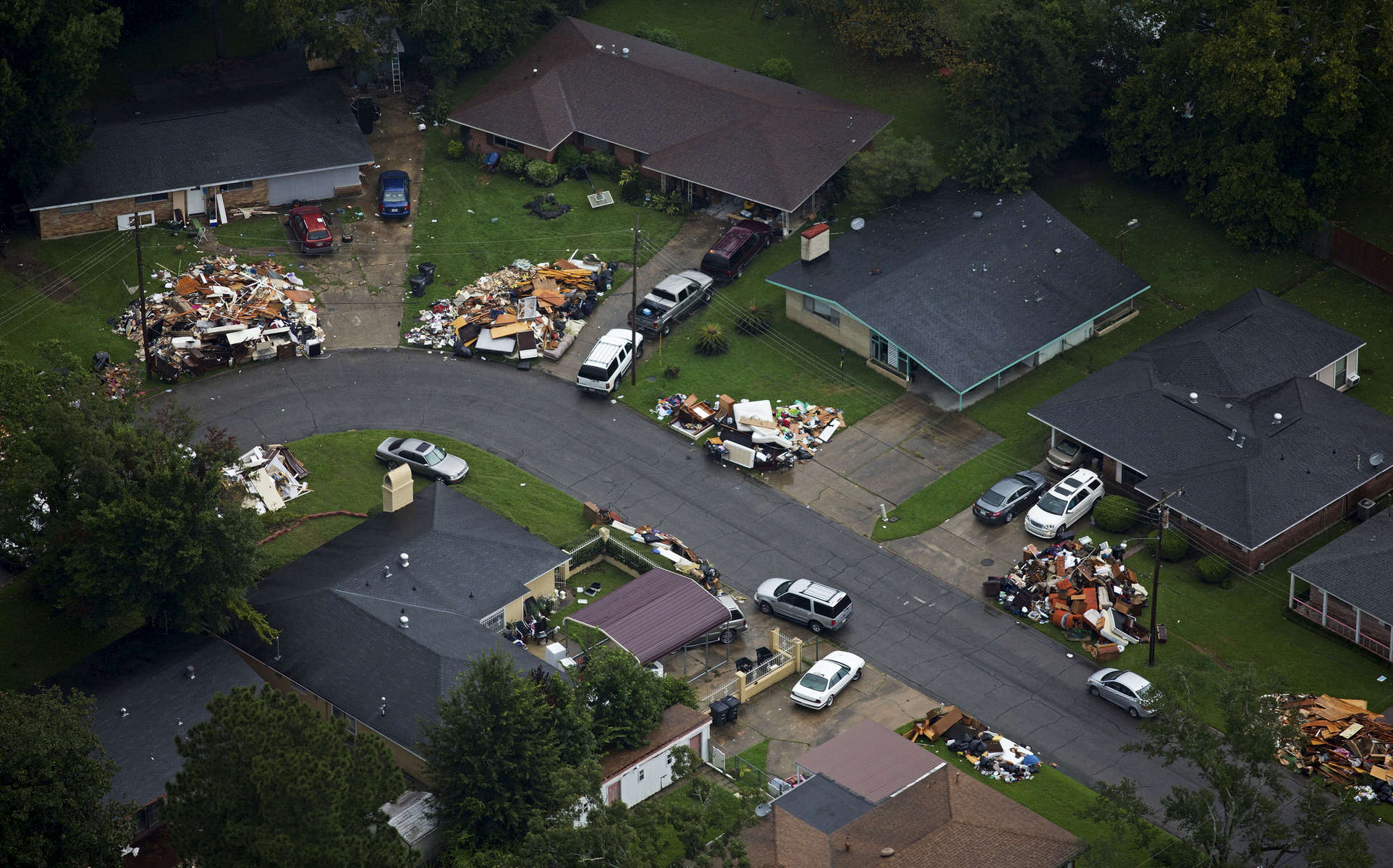 Debris from gutted homes can be seen in front of homes in this areal view of Baton Rouge, La. USA, Thursday, Aug. 25, 2016. President Obama signed a Louisiana disaster declaration on Aug. 14, making federal disaster funding available. (AP Photo/Max Becherer)