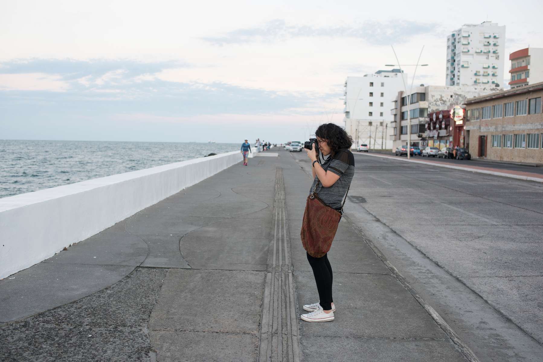 Abril, photography student. Malecon boardwalk from Boca del Rio to port. Puerto de Veracruz, Mexico