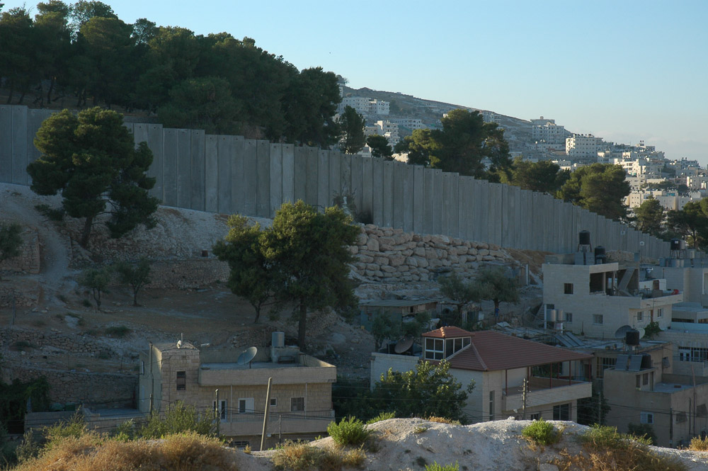 Al Ezariya, a Jerusalem suburb, is separated from Jerusalem by a 26 ft concrete wall. It snakes in and out separating houses, and families.