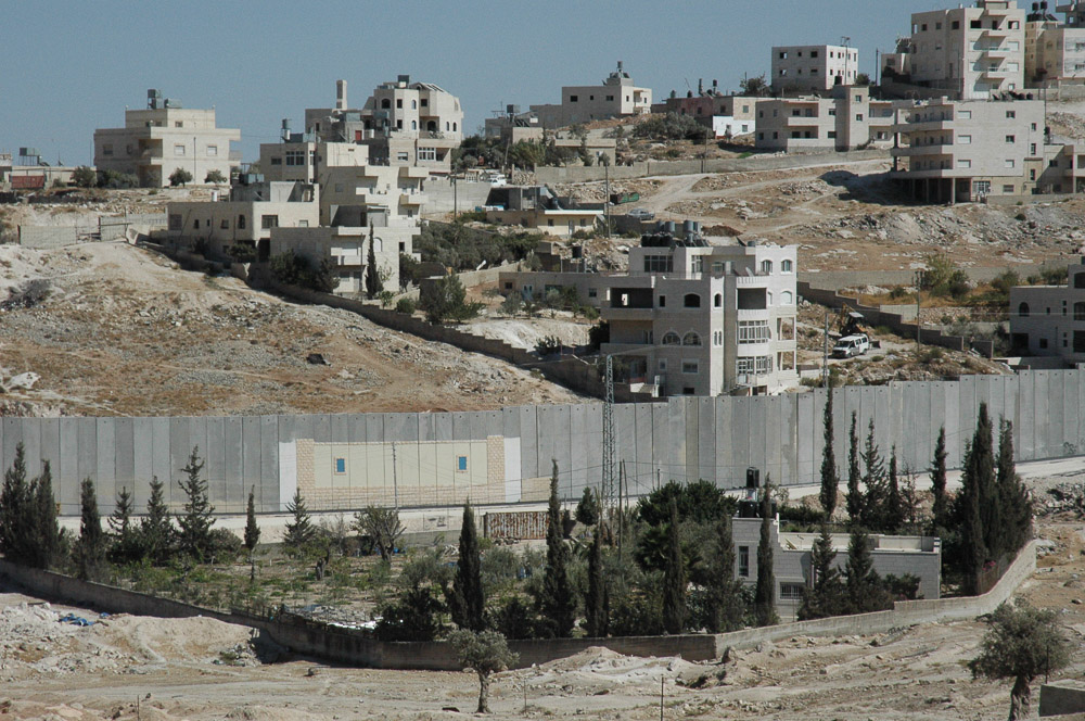 Al Ezariya, a Jerusalem suburb, is separated from Jerusalem by a 26 ft concrete wall. It snakes in and out separating houses, and families.