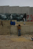 Bethlehem is enclosed by a 26 ft concrete wall. It snakes in and out separating houses, and families.