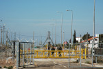 Mas'ha is enclosed by a separation fence, the other side an Israeli settlement in the West Bank.