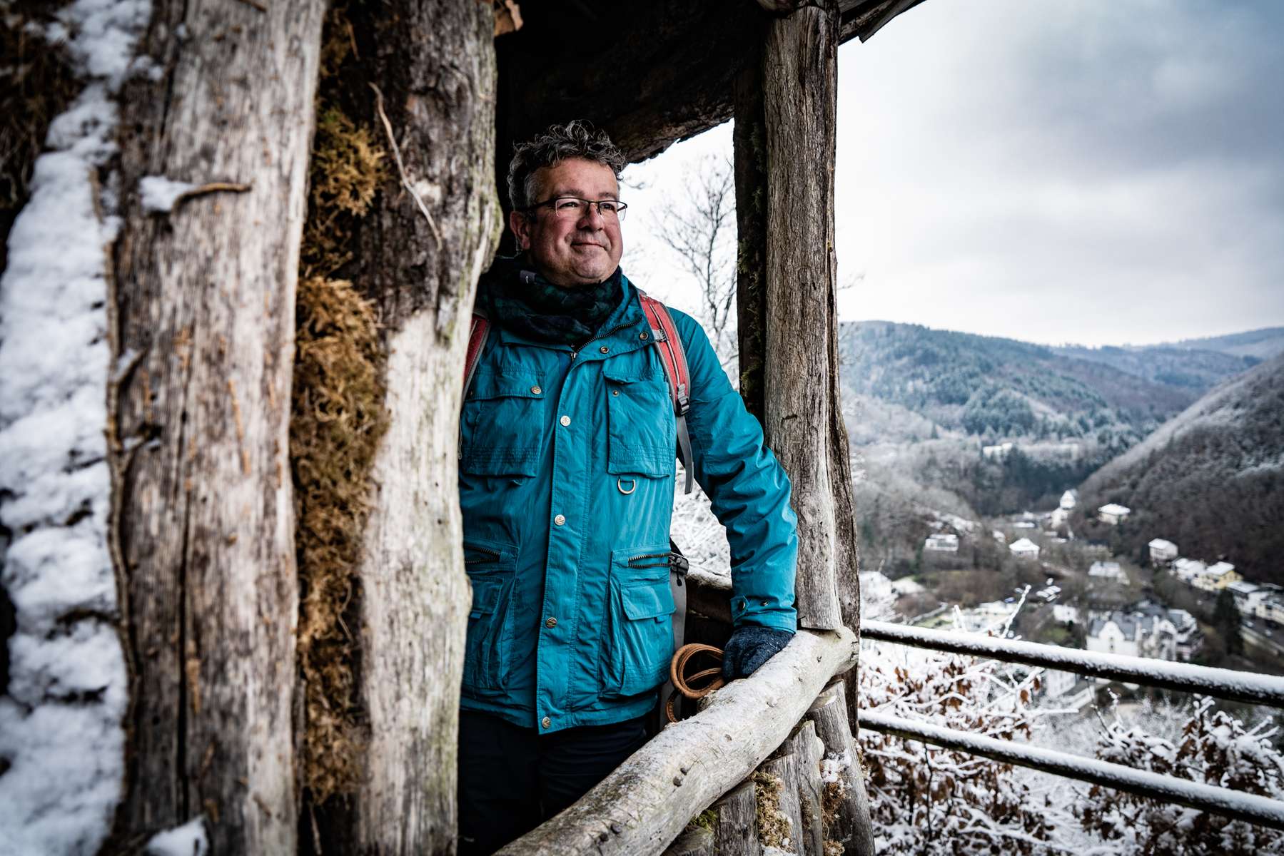 Germany's best known hiker Manuel Andrack is viewing the panorama from a hiking hut in the Vulkaneifel region in Germany