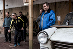 Men in the German Saar region are standing next to an old car and are playing the game Petanque