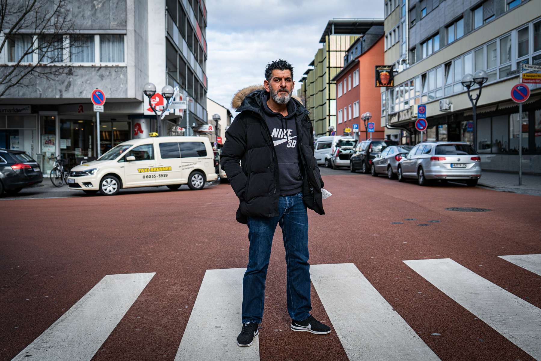 Cetin Gültekin is standing on a street close to a bar in the city of Hanau where his brother Gökhan und eight others were one year earlier by a right wing extremist.