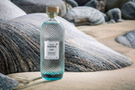 Harris Distillery gin bottle on the beach