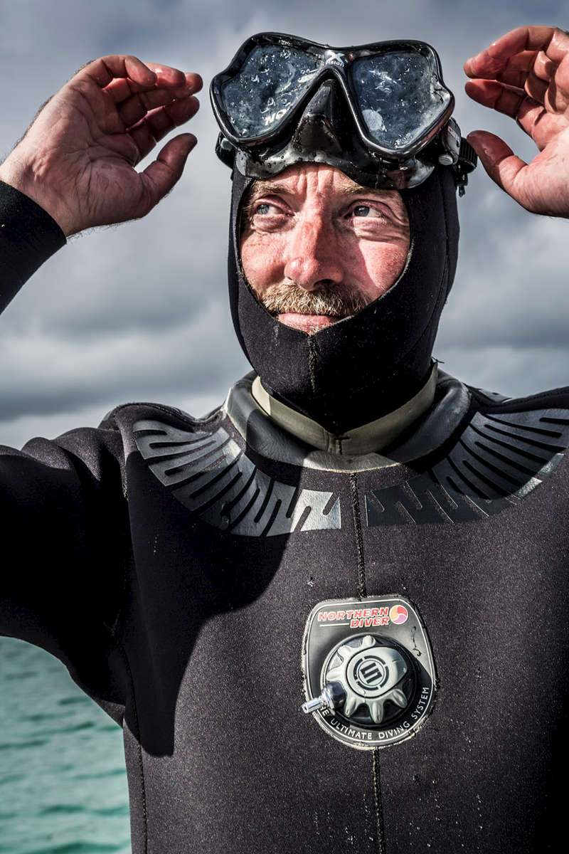 Lewis Mackenzie harvesting sugar kelp in his wetsuit