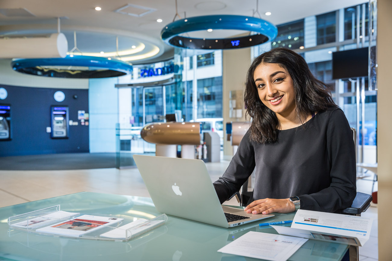 Environmental portrait of young woman at work in a bank.