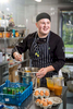 Environmental portrait of young apprentice chef at work in a kitchen