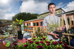 Environmental portrait of young apprentice at work in a garden centre in Shetland. 