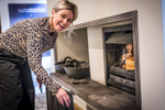 woman feeds Harris Distillery fire