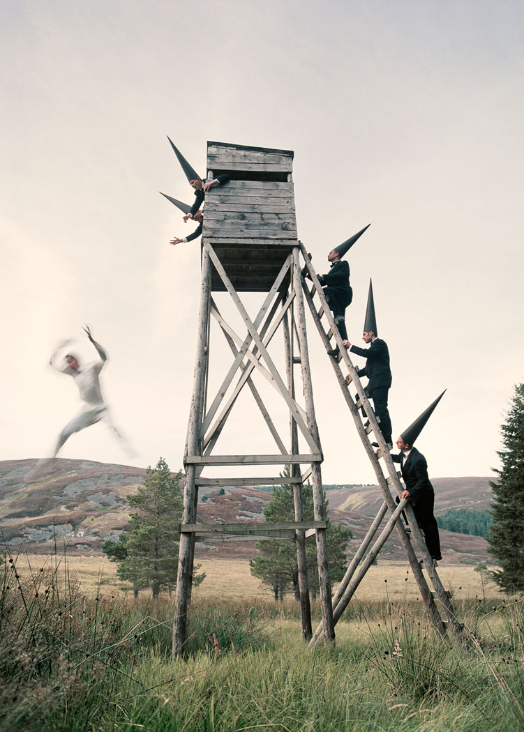 Conemen chasing a man out of a tower