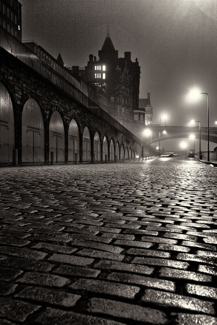 East Market Street Edinburgh. Wet cobbles on a foggy night