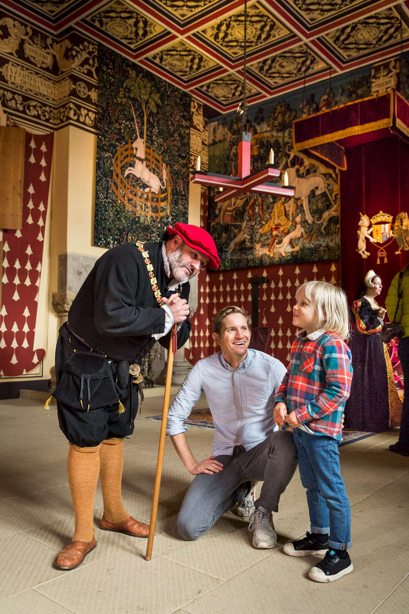 Historic Scotland  - family being shown around Stirling Castle bedroom by a guide in period dress