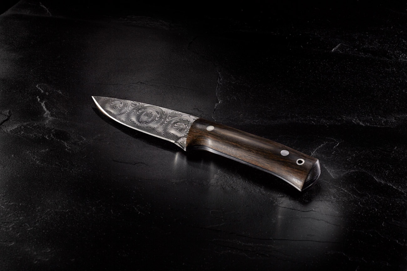 Damascus steel knife on slate