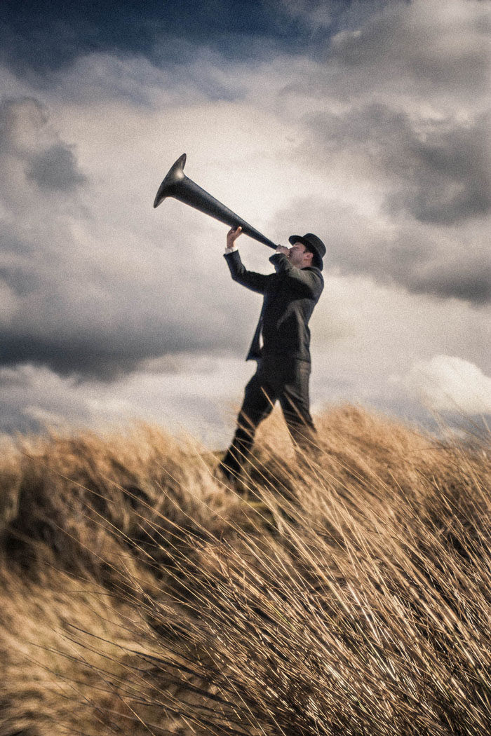 a man blowing a giant horn
