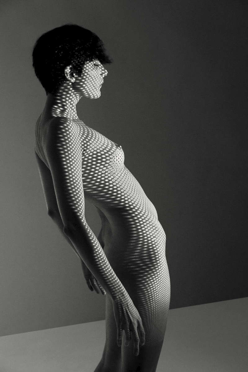 fine art black and white studio female nude with projected spots 
