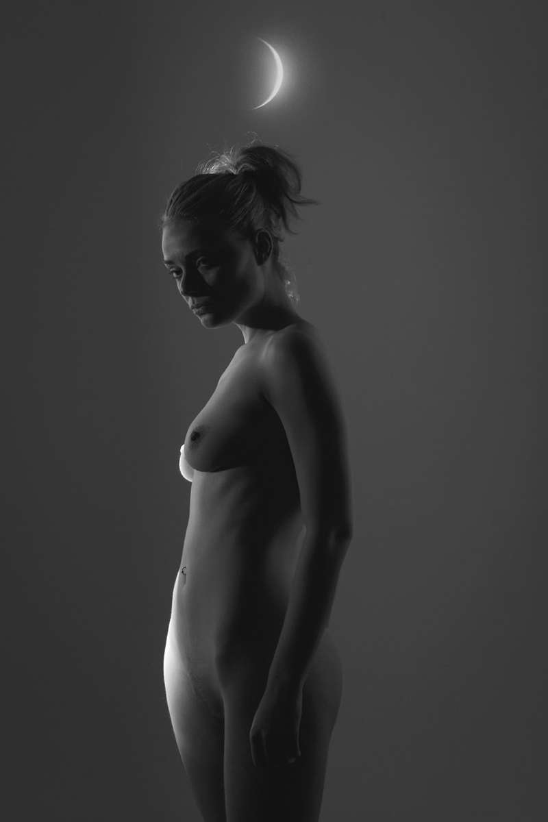 fine art black and white studio female nude with a crescent moon