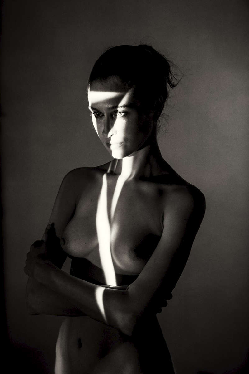 fine art black and white studio female nude with projected slits of light