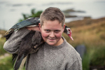 young boy with a duck on his shoulder