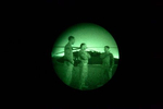 KANDAHAR, AFGHANISTAN - SEPTEMBER 26:Chase Crew Chief (Michael Peña) Center- CW2 Joel Ramos (Pilot), Right- CW2 Alan Harty (Pilot in Command) speaking after a mission, photographed through the lens of night vision goggles the 26th of September 2011, in Kandahar, Afghanistan.(Photo by Rafael Sanchez Fabrés/DPA/LatinContent)