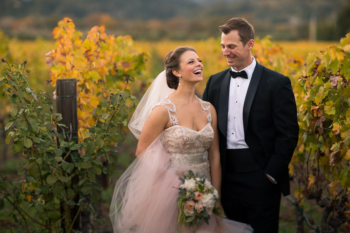 Bride and groom in a vineyard across the Culinary Institute of America, during their wedding there.
